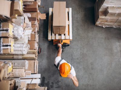 Young man working at a warehouse with boxes Young man working at a warehouse with boxes